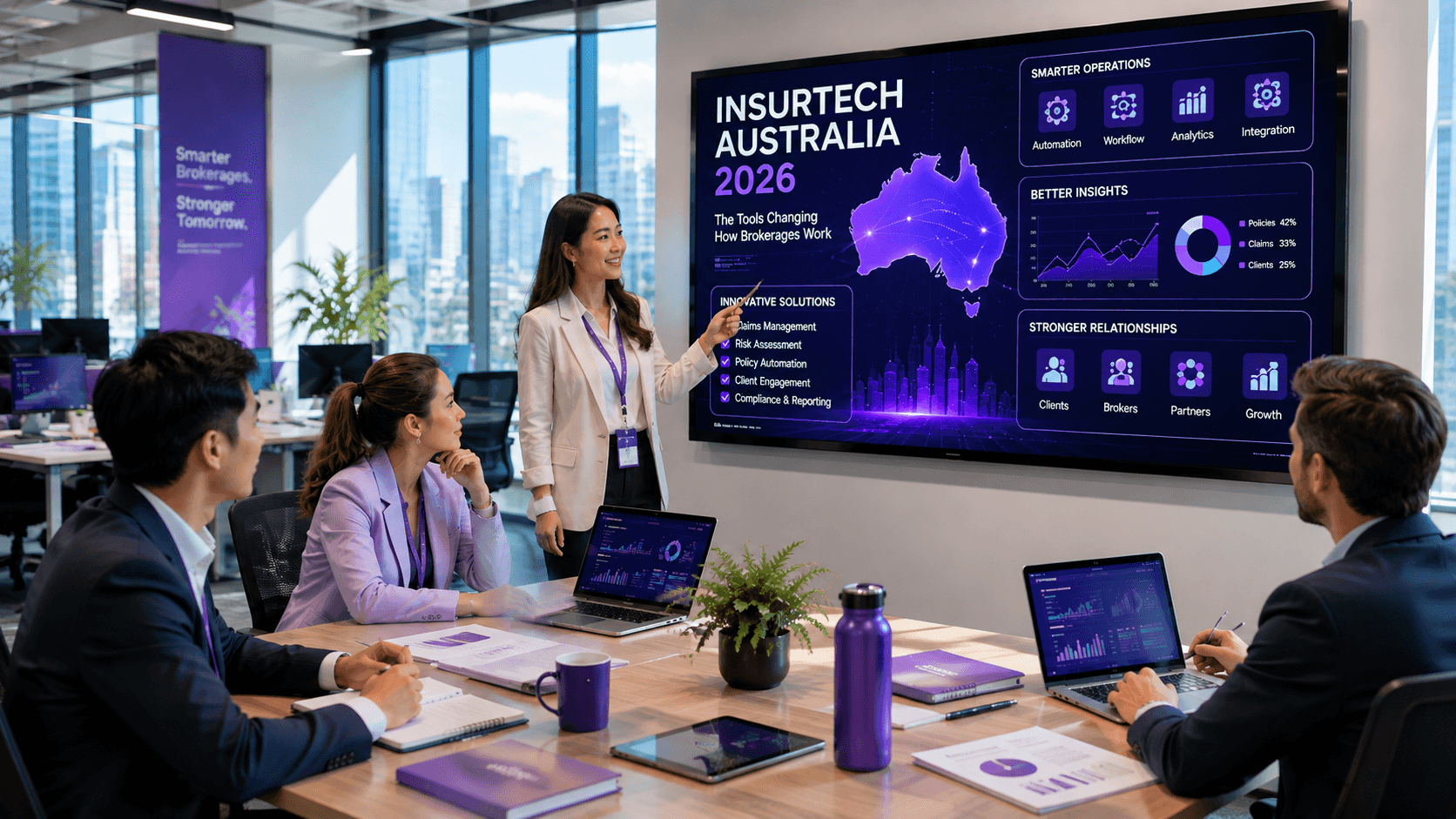 A broker presenting an insurtech dashboard of automation, analytics and compliance tools to a brokerage team