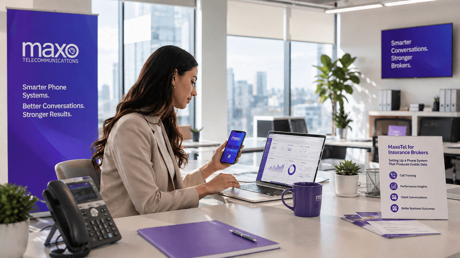 An insurance broker at a brokerage desk reviewing a call reporting dashboard on a laptop, with a VoIP desk phone and MaxoTel branding in the office background
